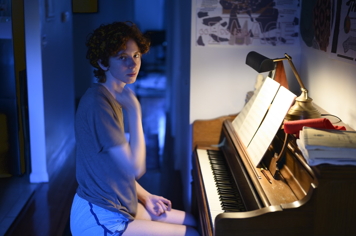 Julia is sitting at the piano.